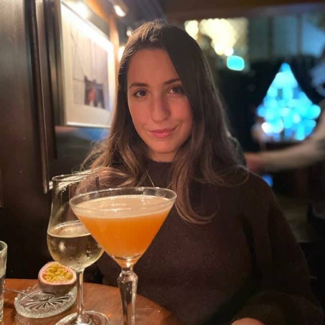 Women smiling with a glass of wine and a cocktail