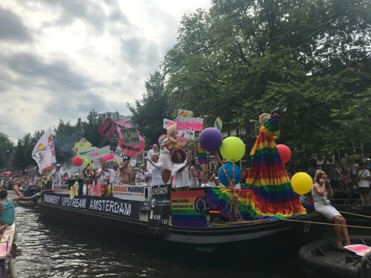 Colorful Boat for Gay Pride with Rainbows and signs around Love = Love