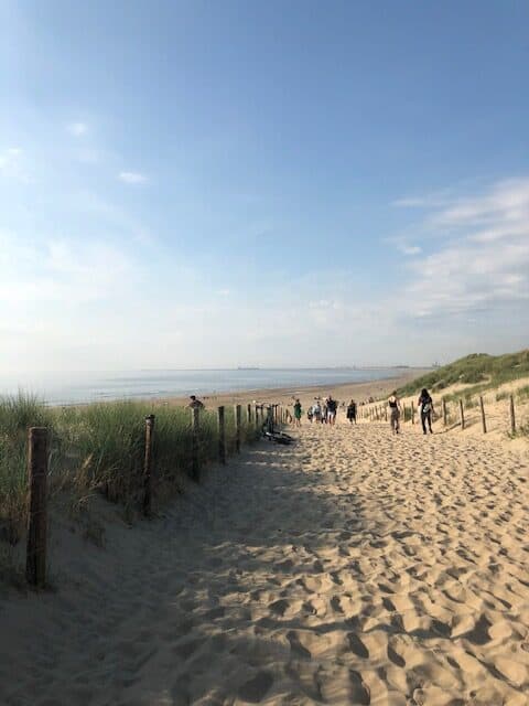 People walking down to the beach in Bloemendaal; blue sky and sand