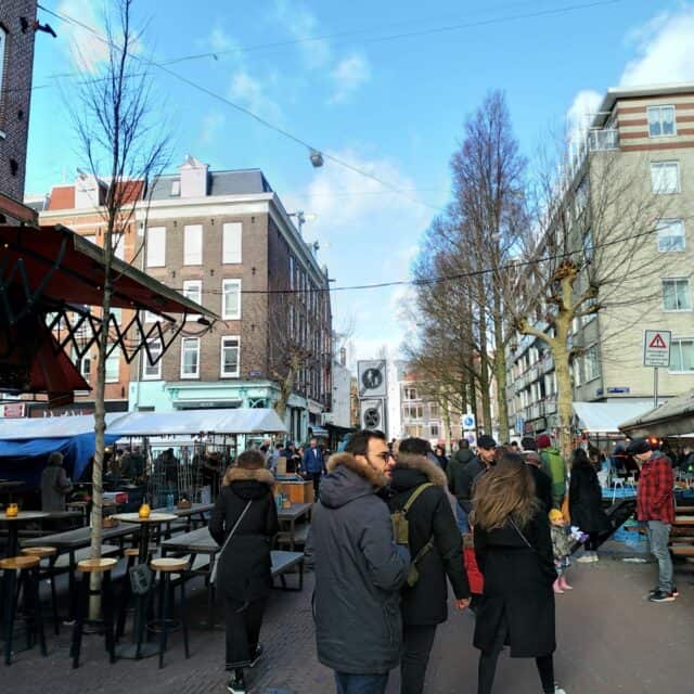 People walking through the Albert Cuyp Market in De Pijp Amsterdam