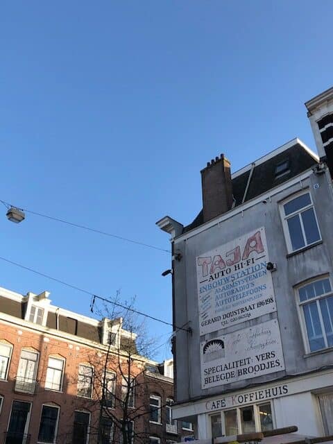 Old Buildings and a blue sky with a sign for Cafe Koffiehuis