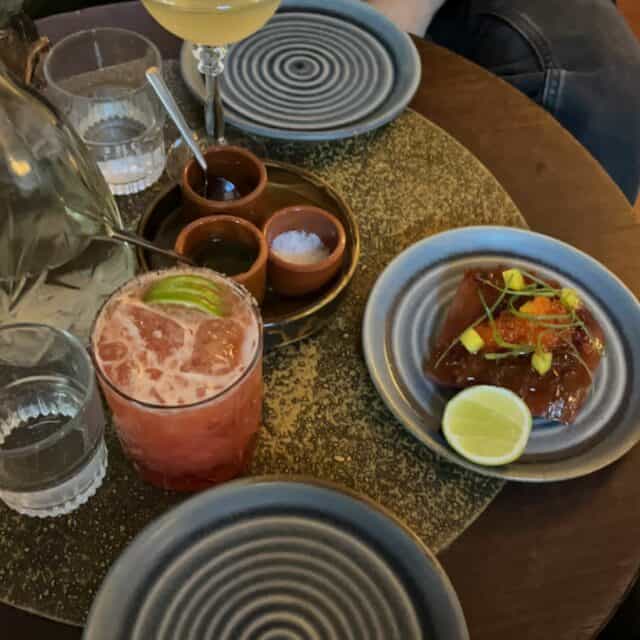 Colorful table at a Mexican restaurant with a margarita, and taco