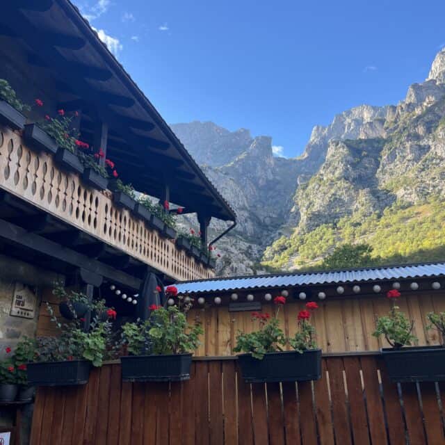 Mountain escape home with red flowers with Spanish Mountains in the background - our Home Exchange Reviews location for our first bookings