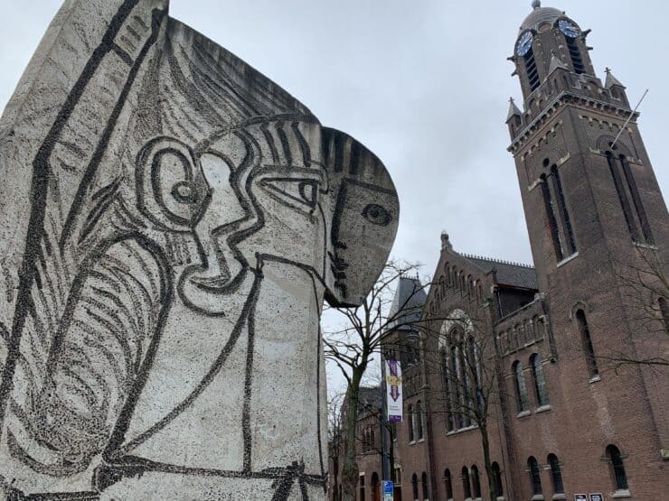 Picasso white statue and old church in Rotterdam